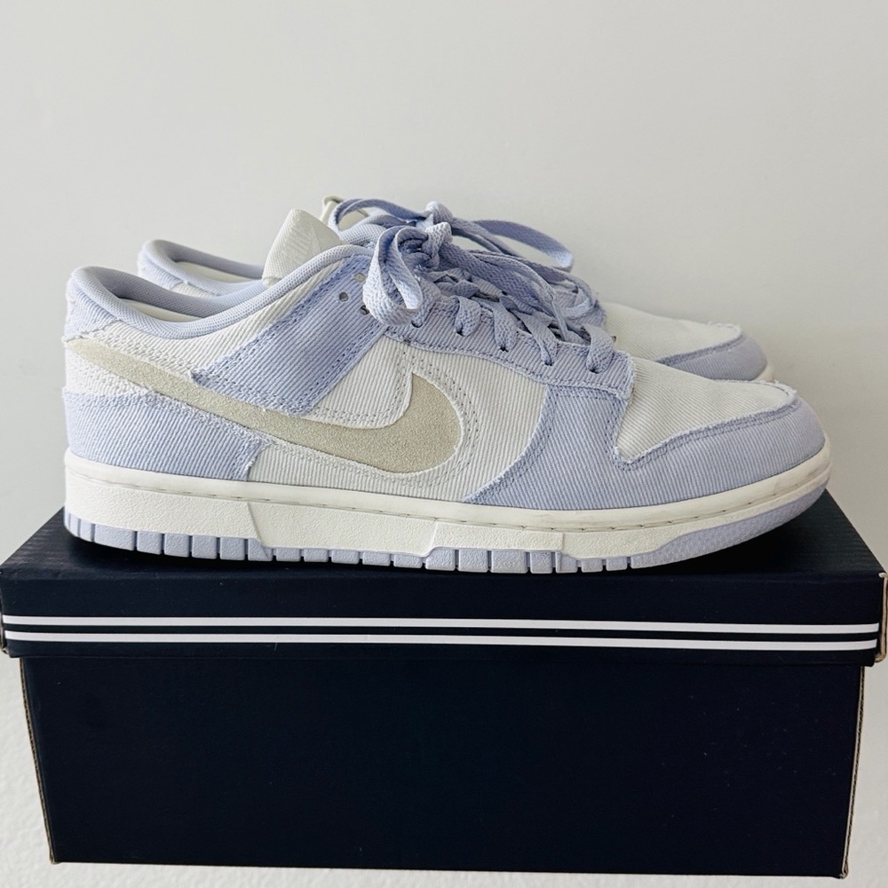 The sneakers are Nike Dunk Low Women's Shoes in the Ghost/Platinum Tint/White